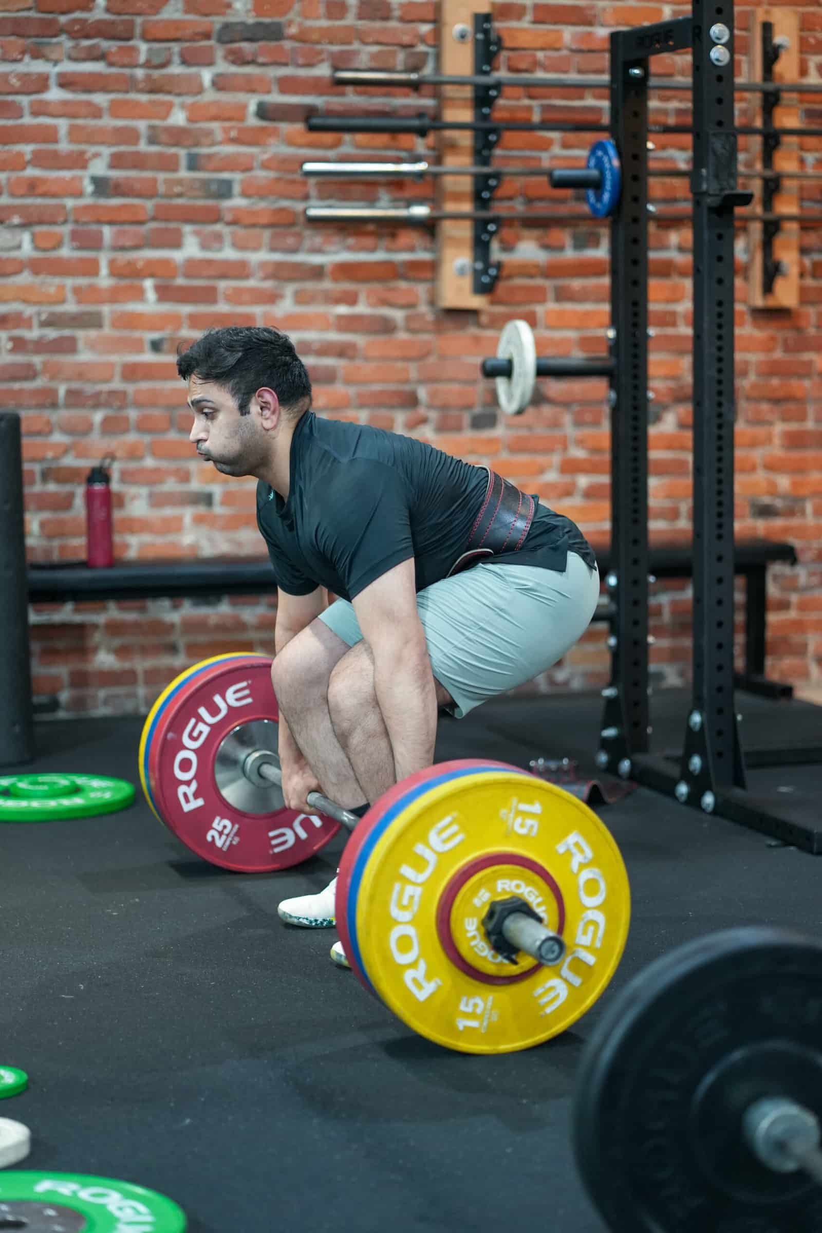 Coach giving a form correction during a coached class at Persistence Athletics, Belltown Seattle