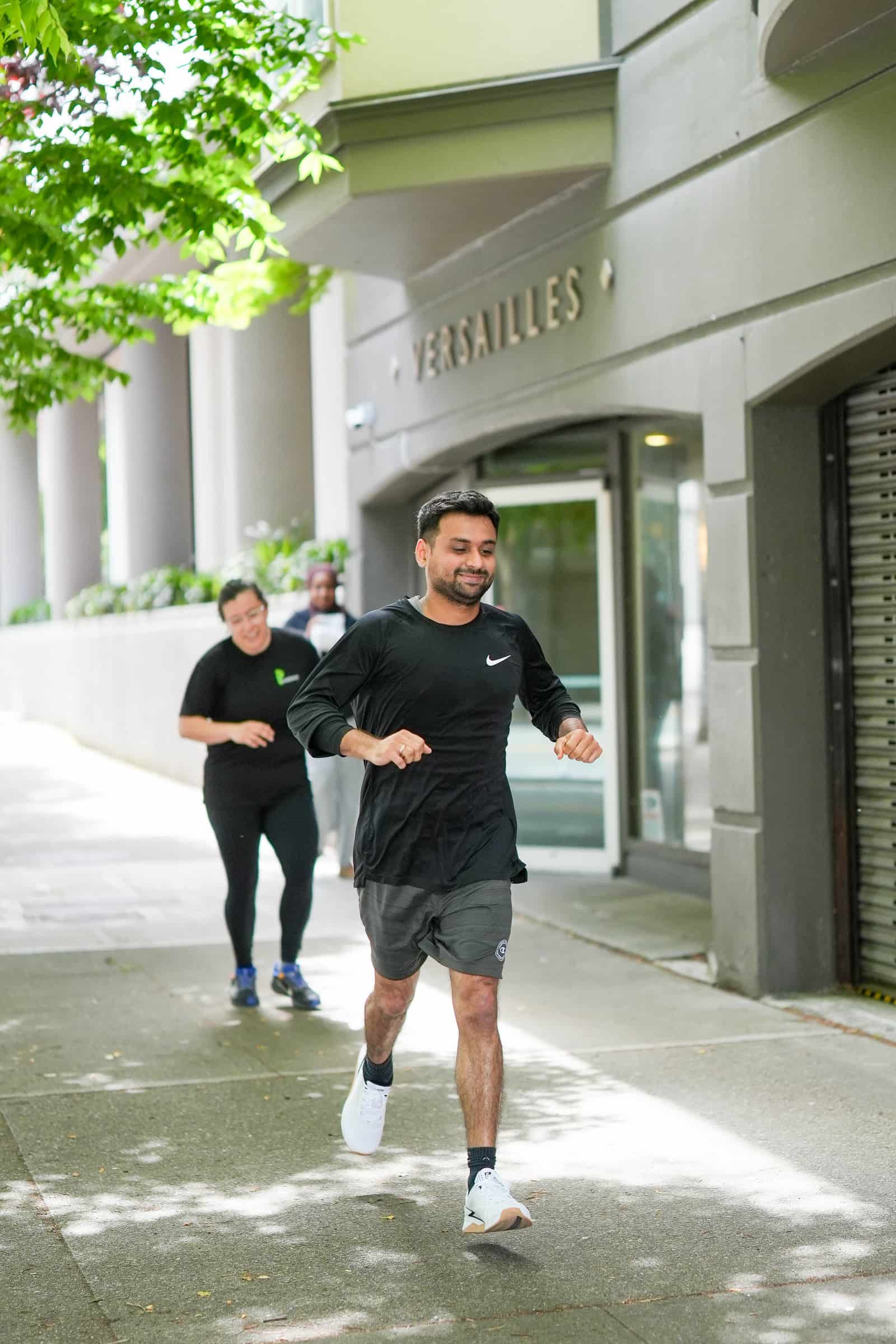 Persistence Athletics member running through Belltown streets during Murph, Seattle