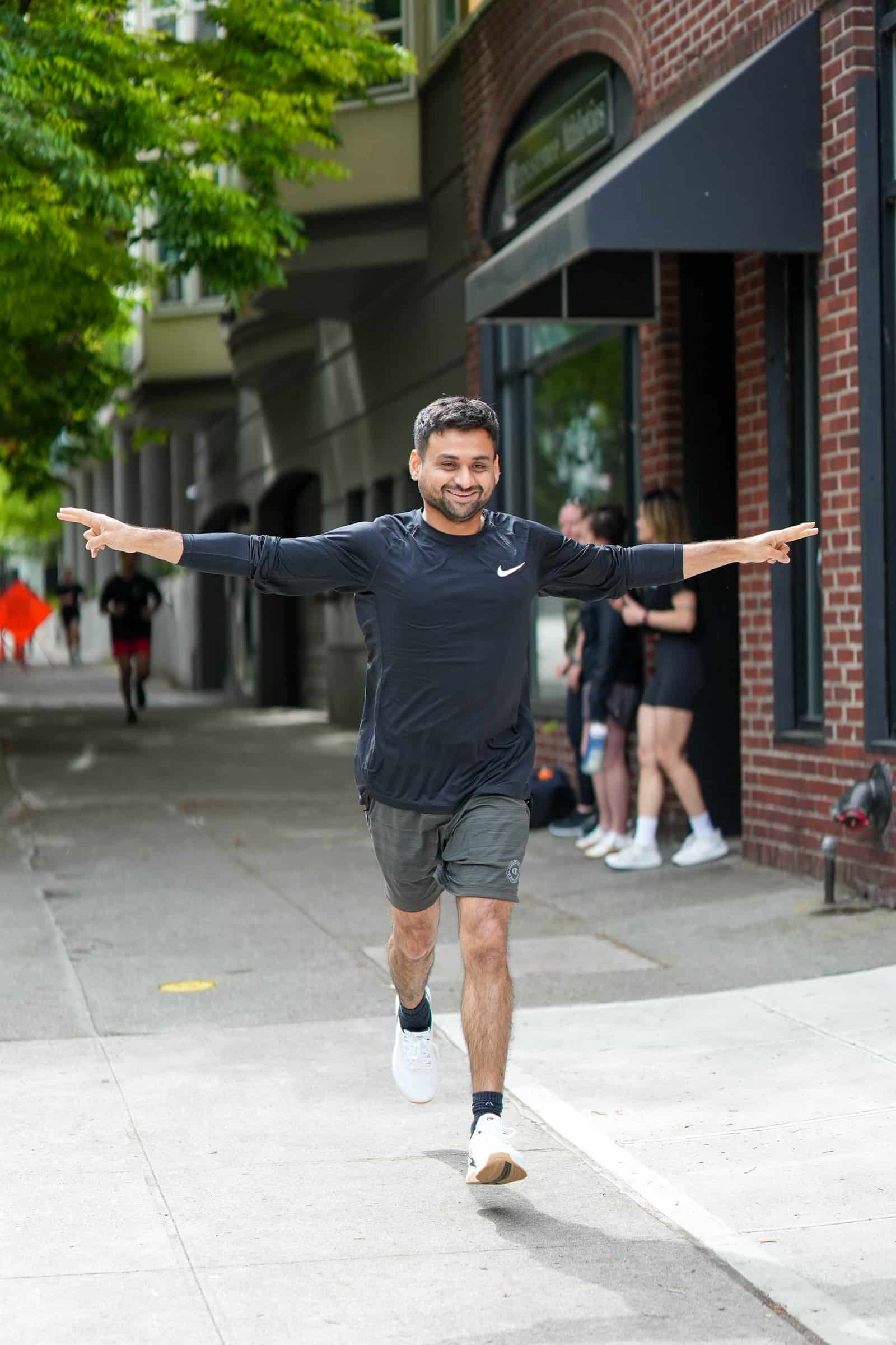 Persistence Athletics member celebrating through a tunnel of arms, Belltown Seattle