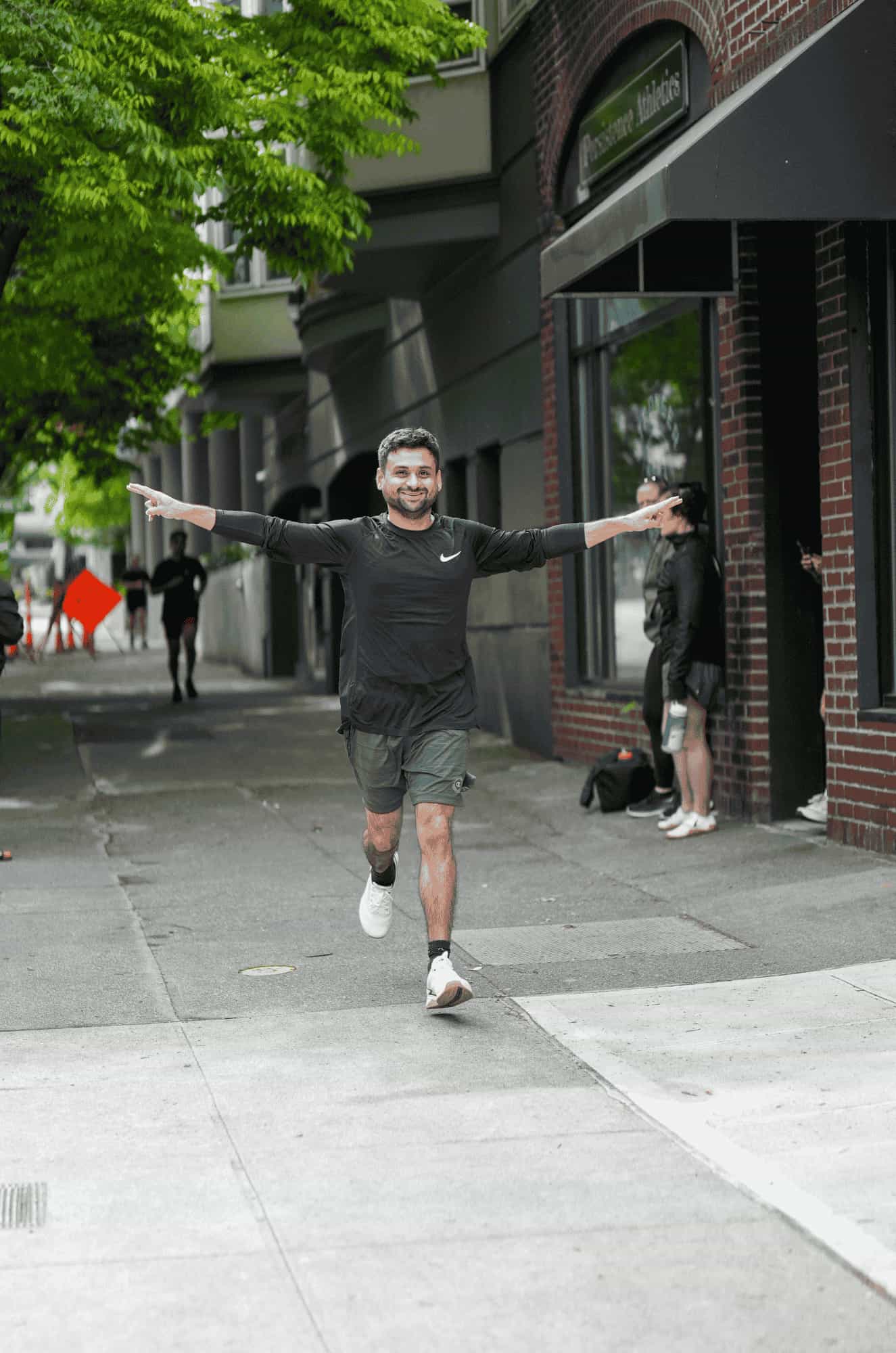 Member Aman running during a HYROX-style session at Persistence Athletics, Belltown Seattle