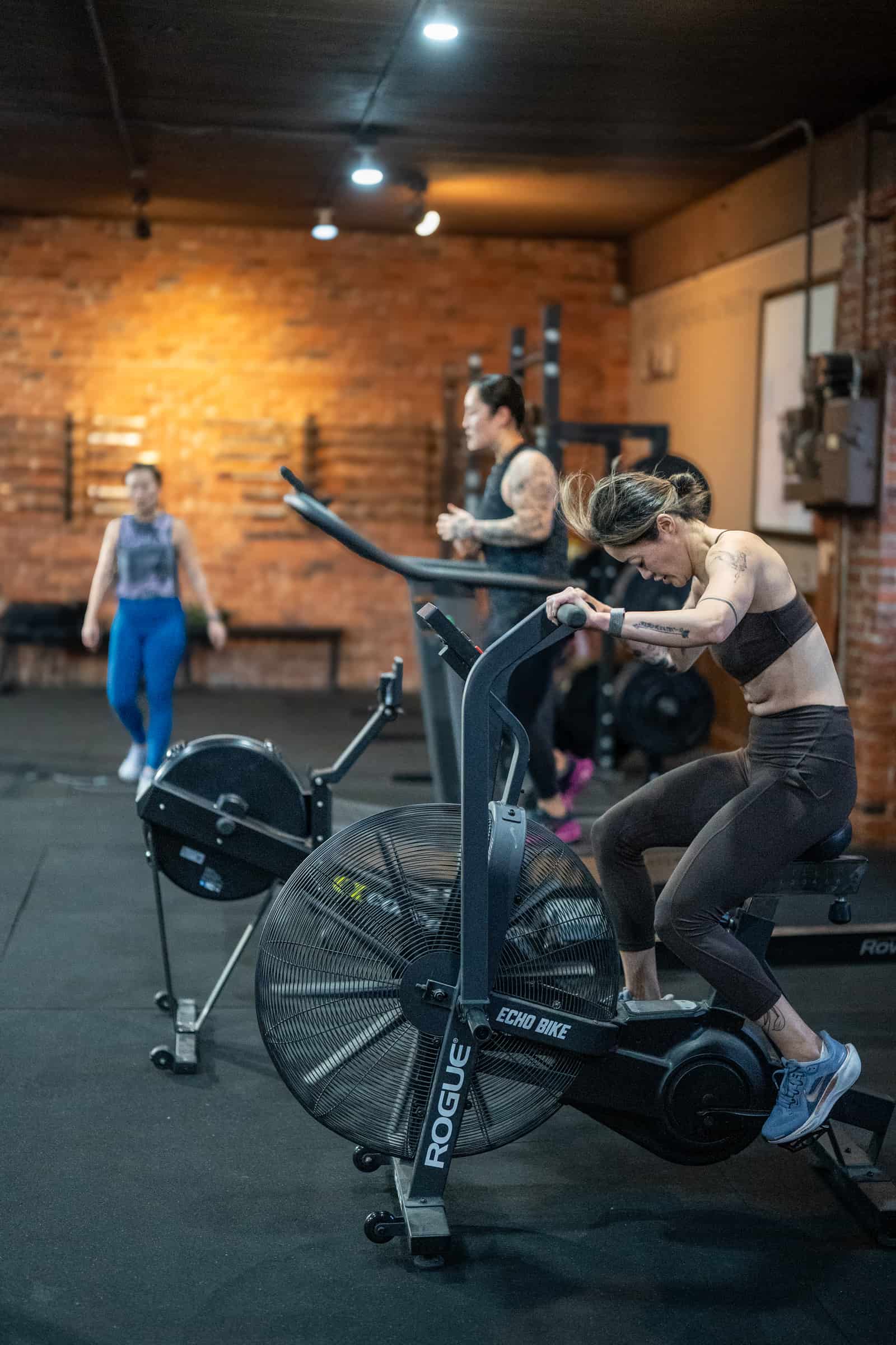 Member on the assault bike at Persistence Athletics, Belltown Seattle