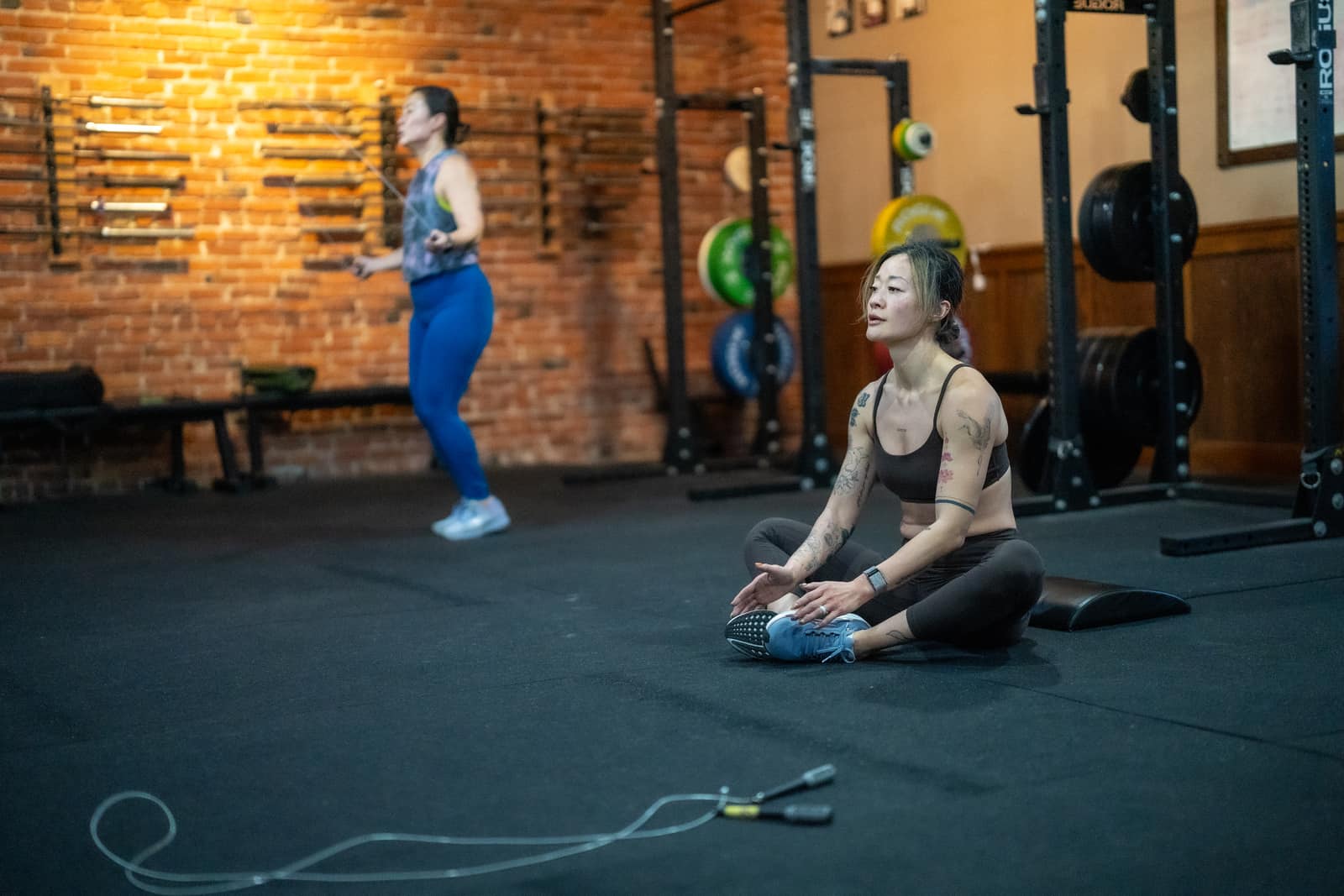 Member stretching and recovering after a class at Persistence Athletics, Belltown Seattle