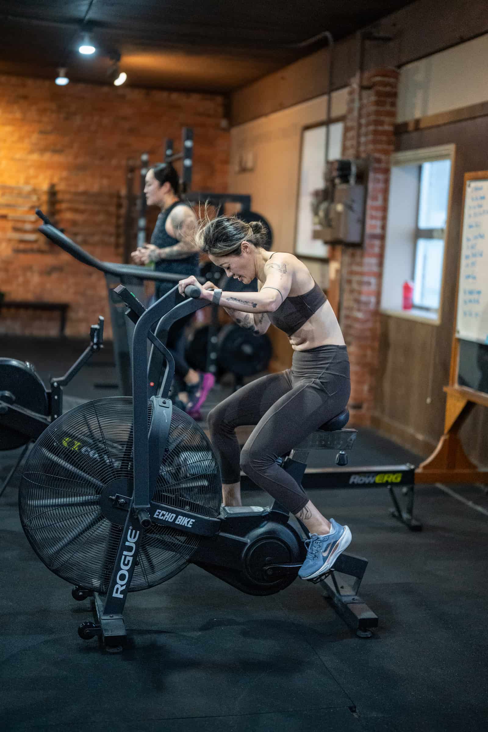 Member working a coached strength set at Persistence Athletics, Belltown Seattle