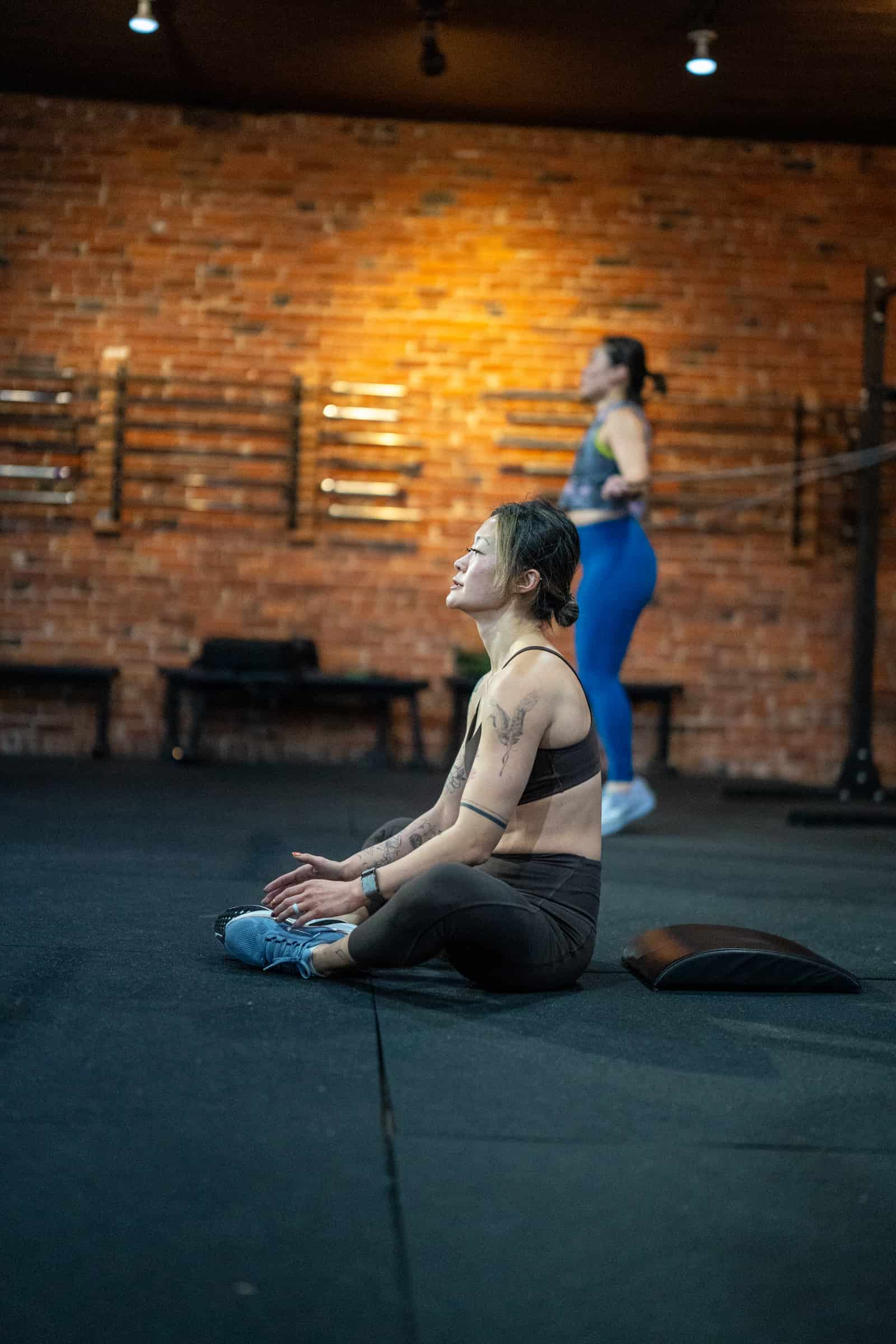 Member stretching during a coached class at Persistence Athletics, Belltown Seattle