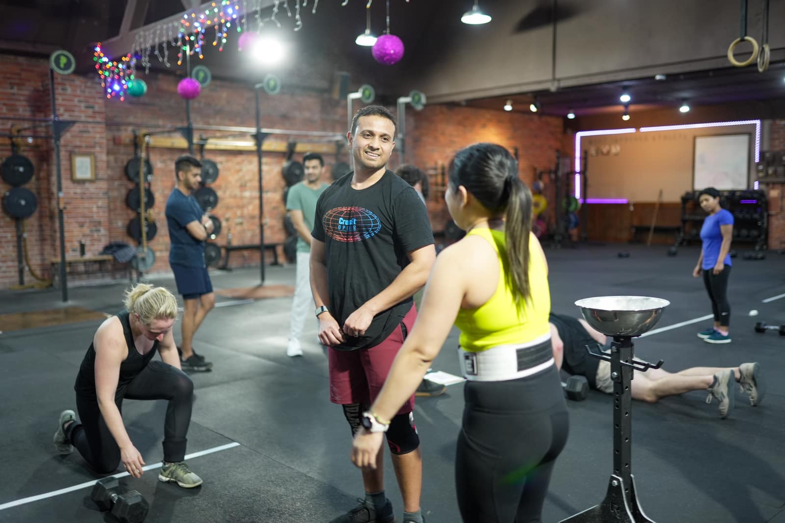 Member working a heavy dumbbell row variation at Persistence Athletics, Belltown Seattle