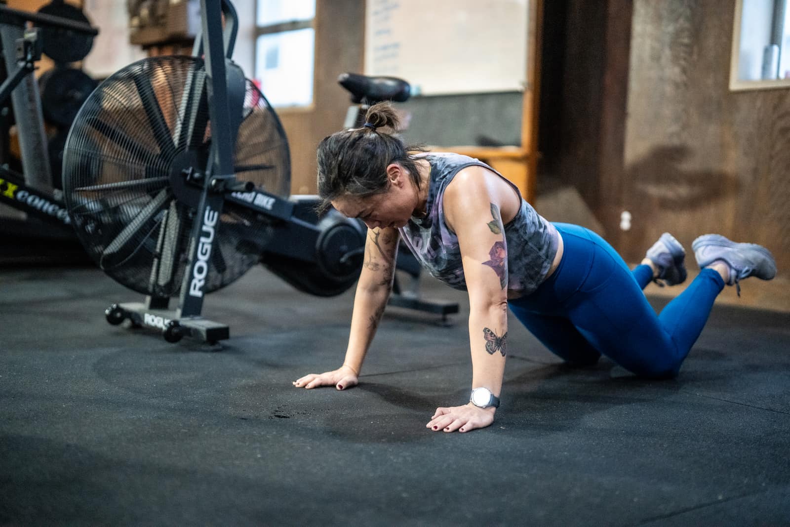 Member at the bottom of a pushup at Persistence Athletics, Belltown Seattle