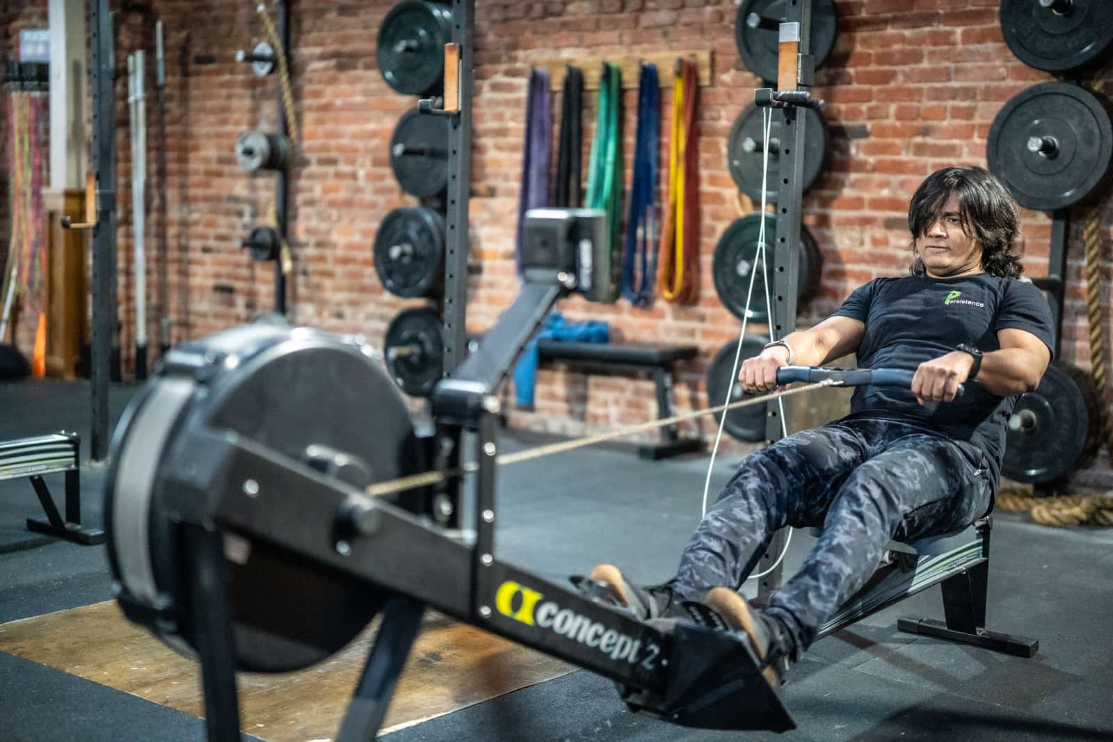 Member resting on the floor between rounds at Persistence Athletics, Belltown Seattle